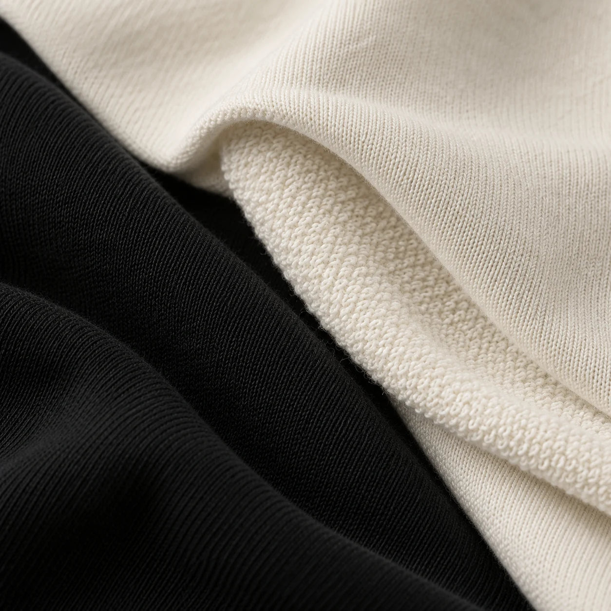Illustration of black and off-white French terry cotton, showing the smooth outer knit and soft inner loops